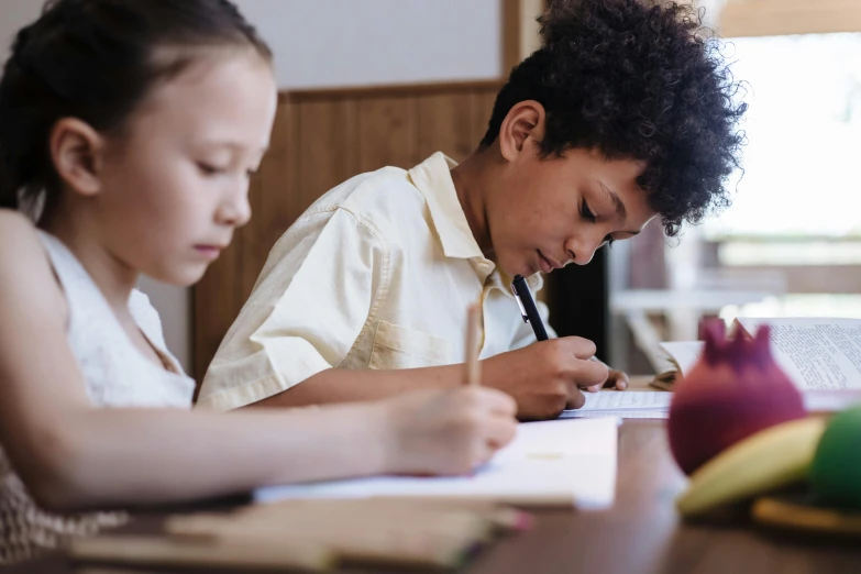 a  is writing while a man watches