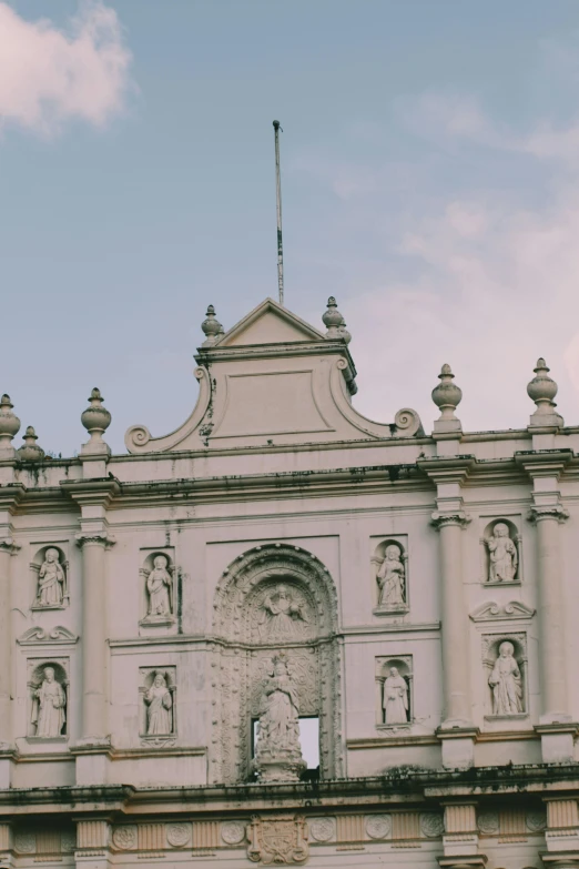 an old style building with a flag at the top