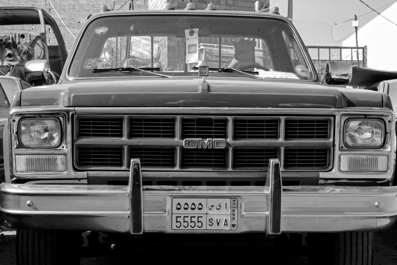 a parked black and white truck with front grills