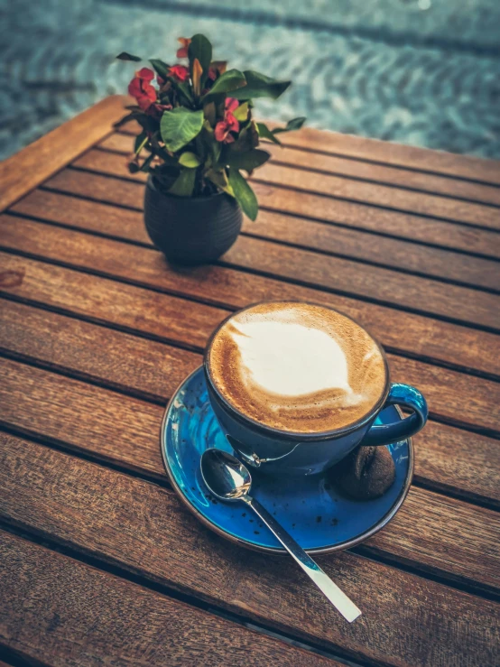 a coffee cup on a saucer with sugar