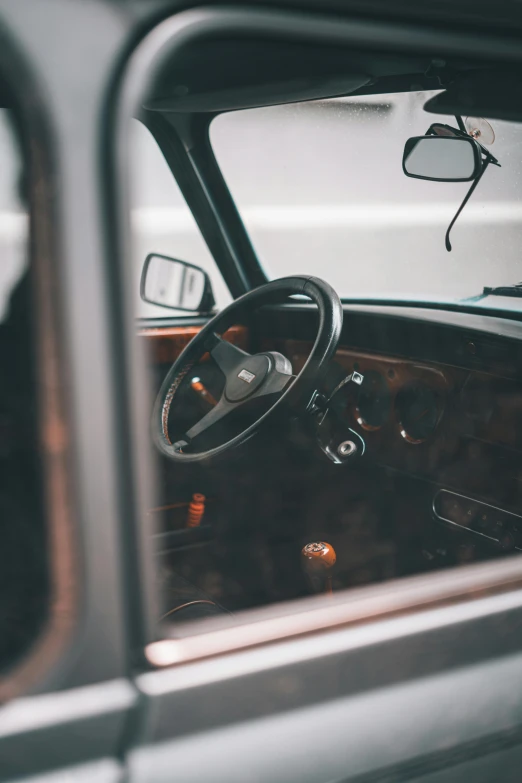 interior of old station wagon vehicle with dashboard and steering wheel