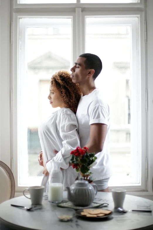 two people that are looking out a window