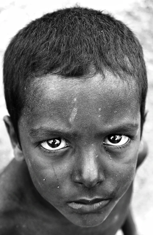 a boy with the upper half painted black, posing for a picture