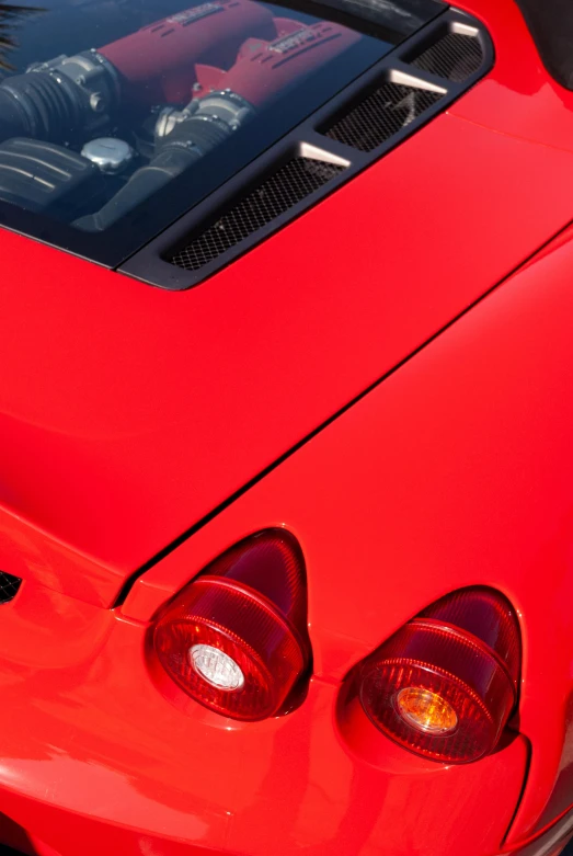 the hood is red and shiny as the interior of a sports car