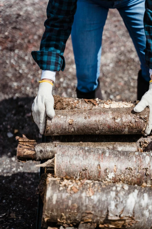 a man is holding a log that has been cut