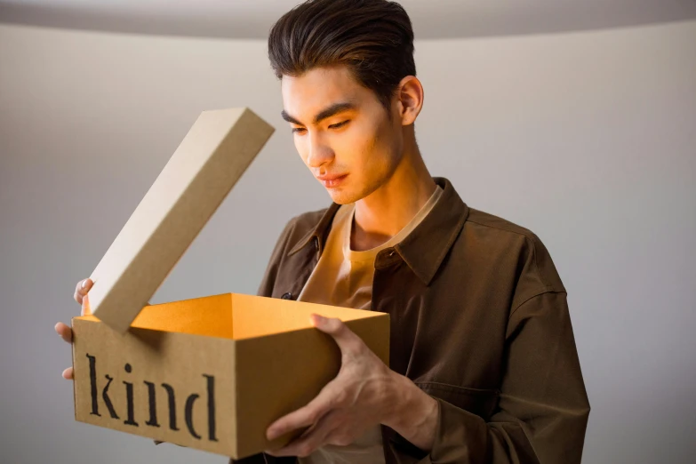 a man holding an open kind of box in his hand