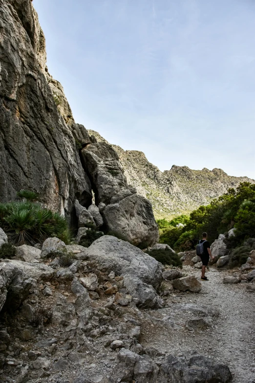 a man is hiking up a mountain side