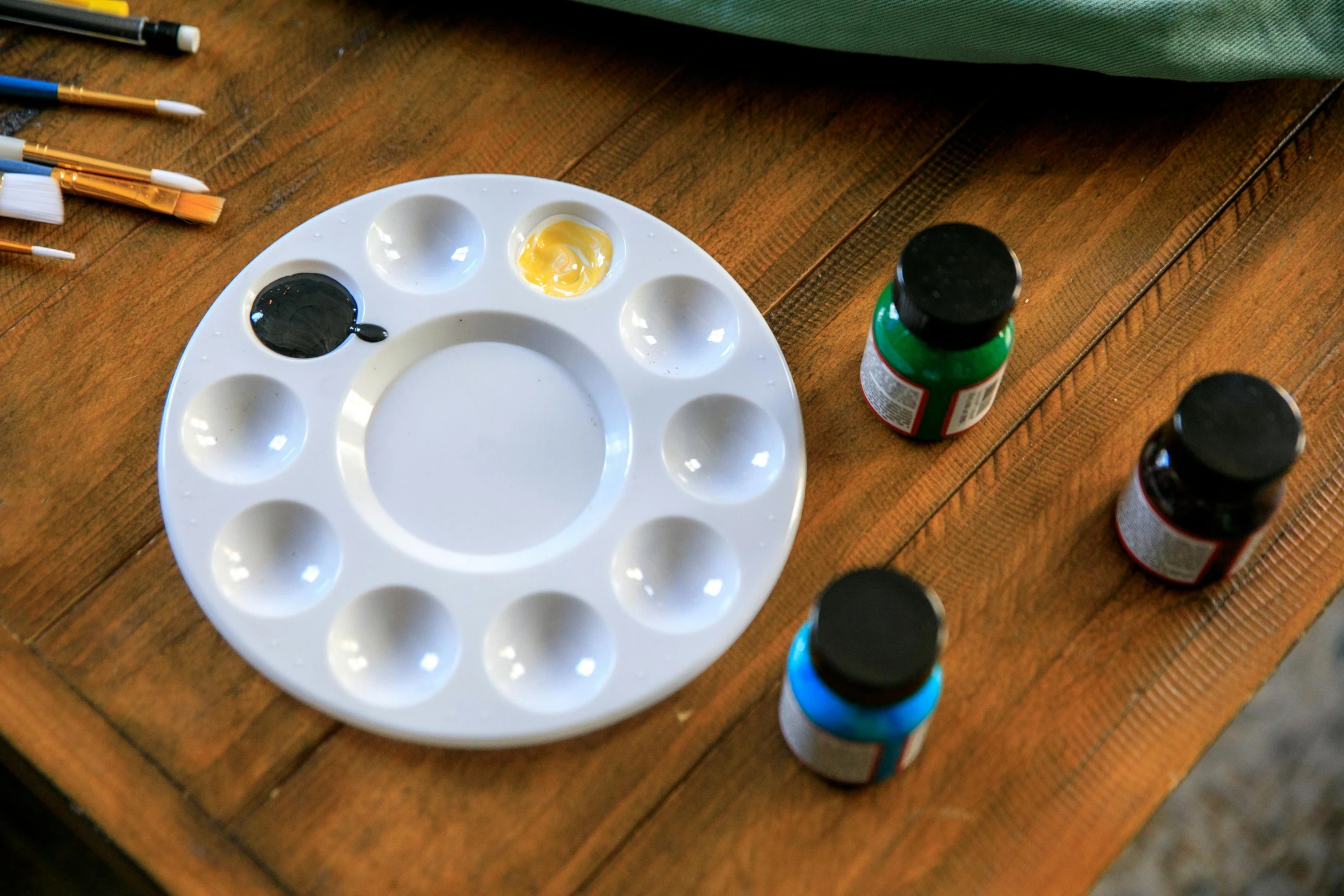 two different types of painting supplies sit on a table