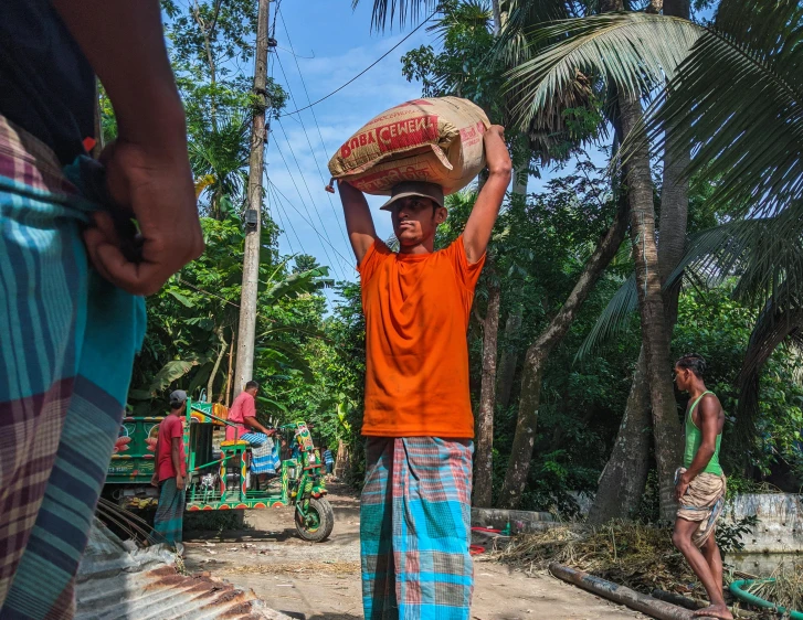 a man carrying a basket on his head