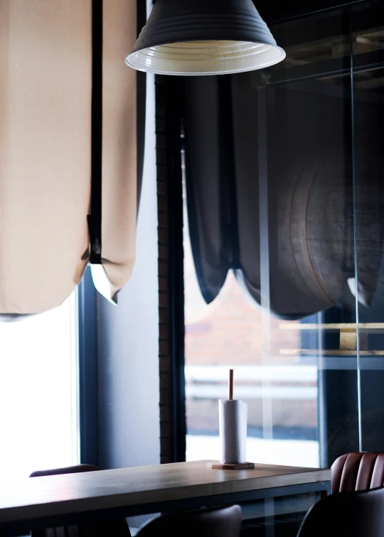 a light hangs in a dark restaurant room