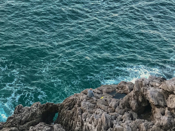 the water is rushing past some rocks by a boat