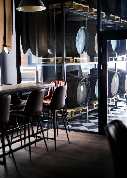 the empty bar and barrel room is seen through the glass walls