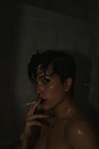 a girl smoking a cigarette in the shower