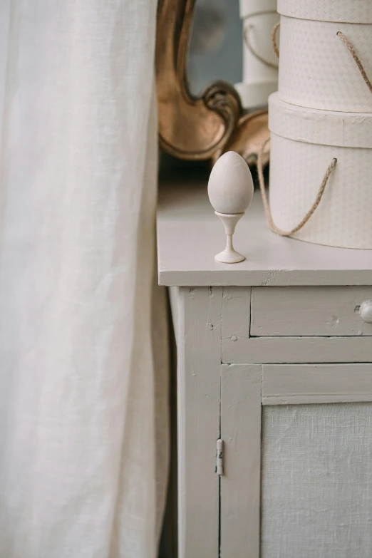 a white dresser topped with lots of different items