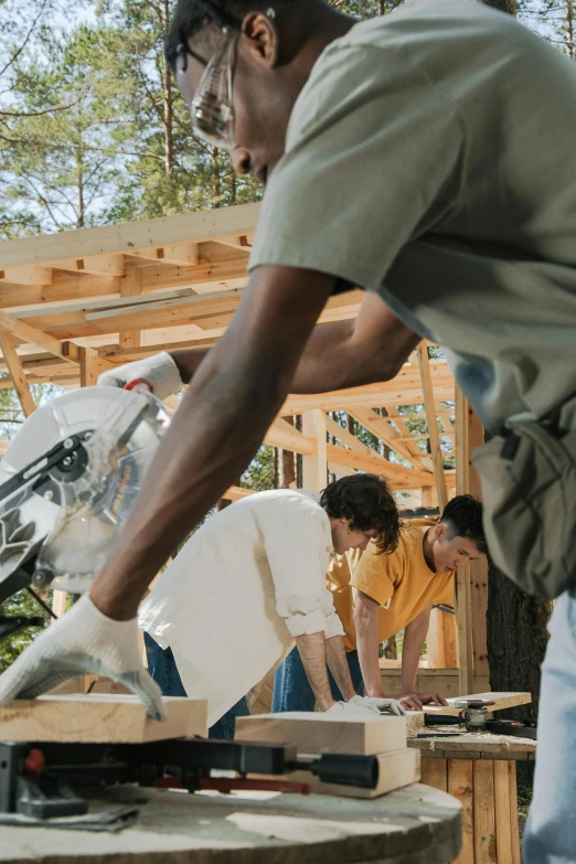 man making a project while another watches on