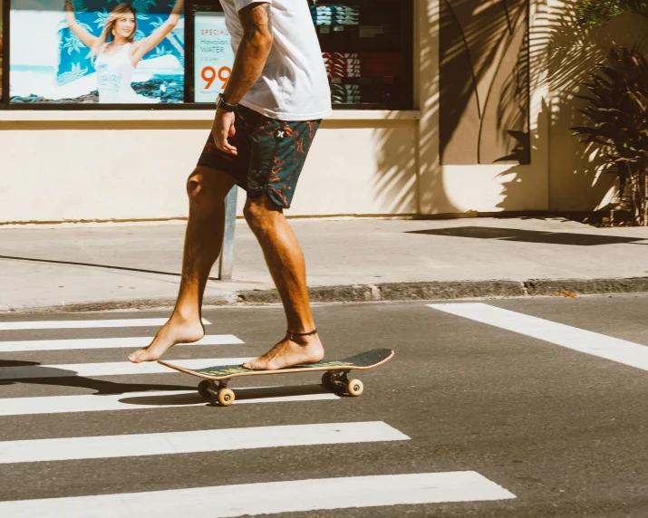 a young man riding a skateboard across a street