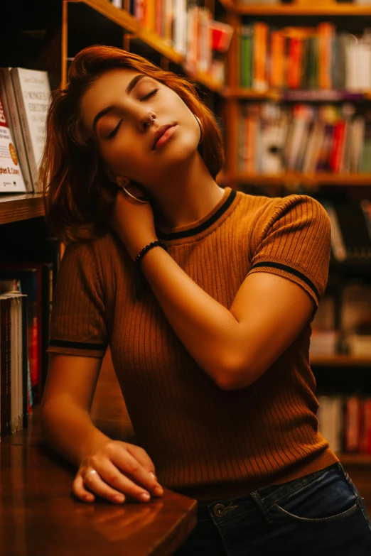 the woman is sleeping in front of bookshelves in a liry