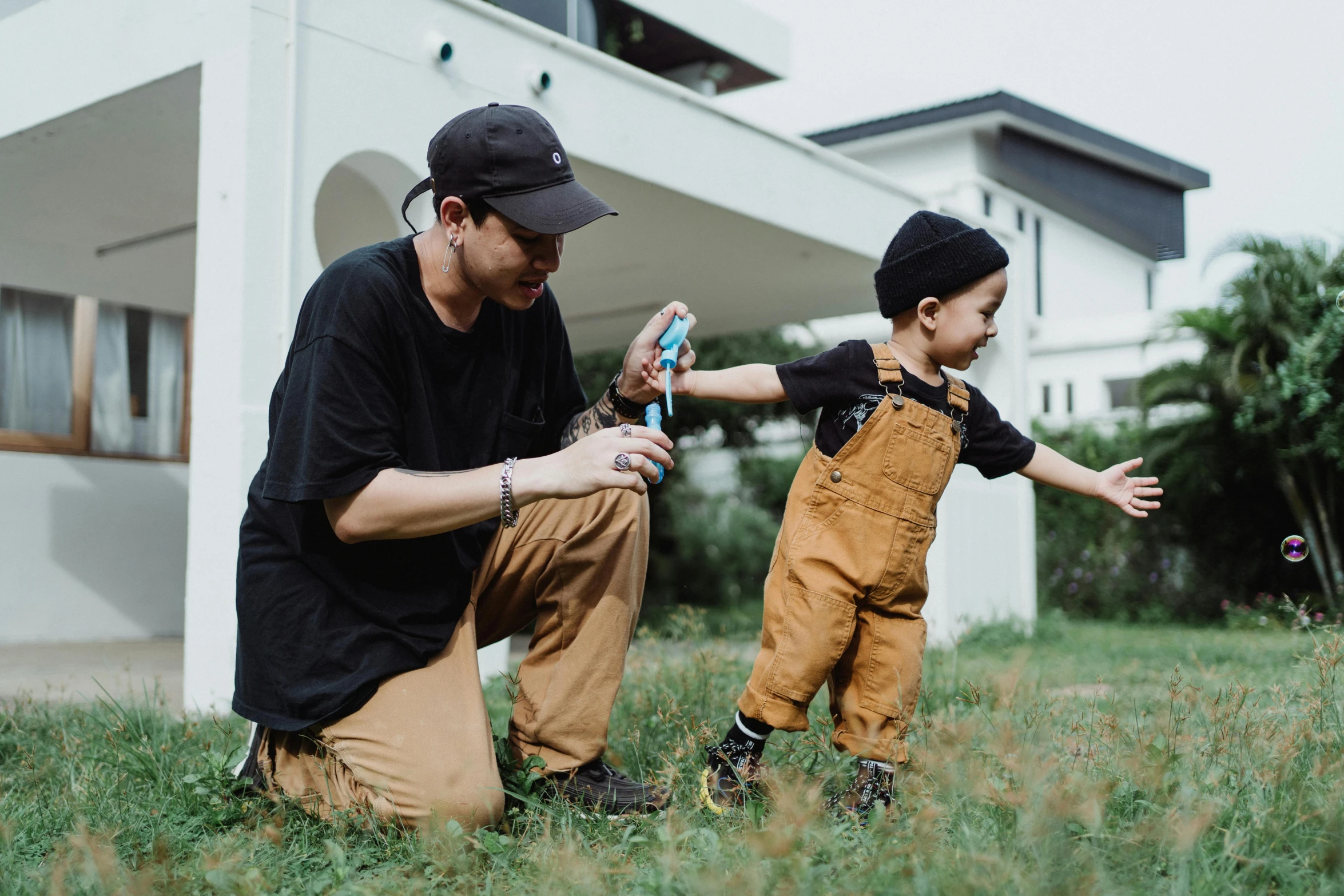 a man and child are playing outside with a phone