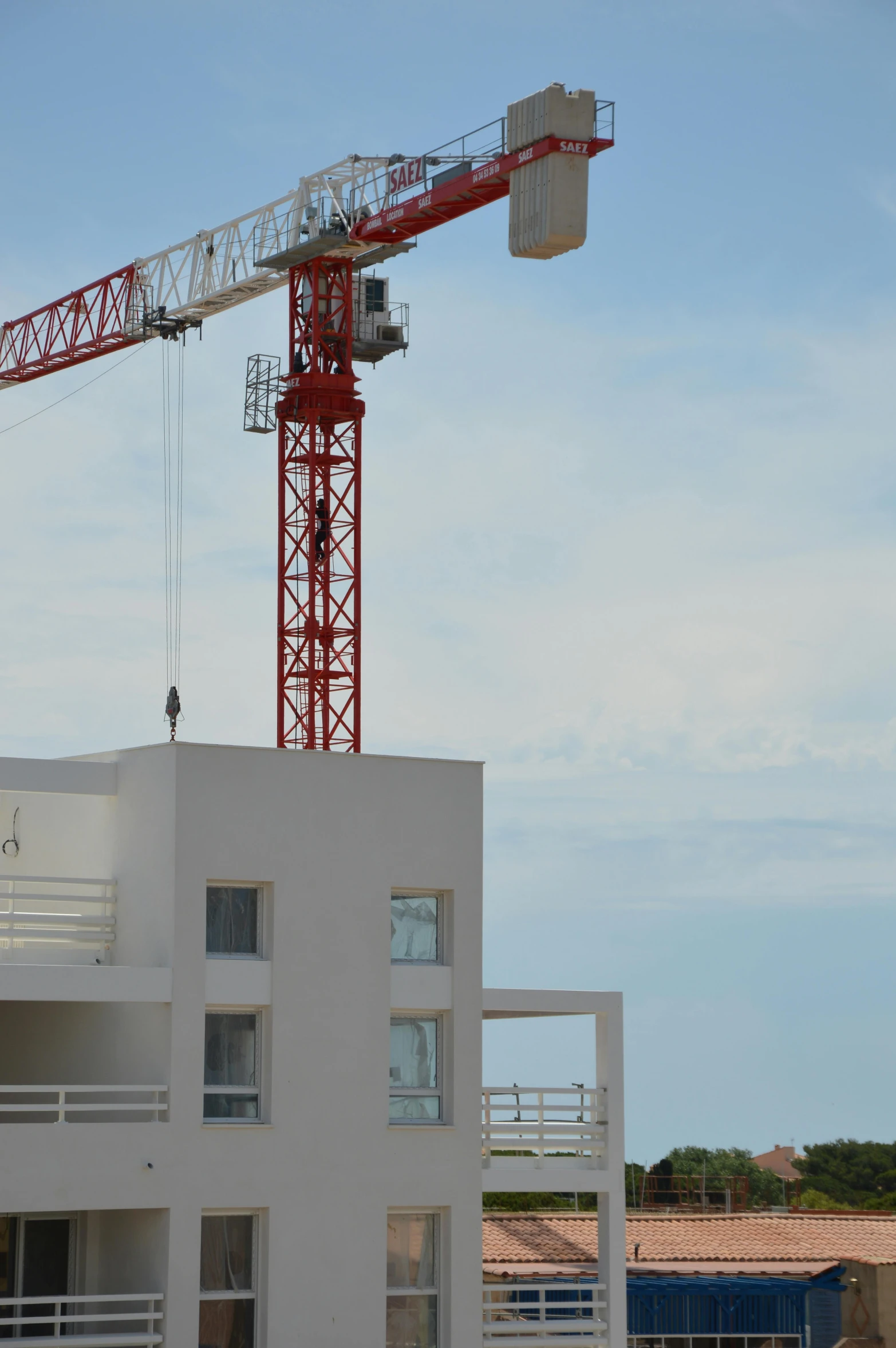 a red crane that is on top of a building