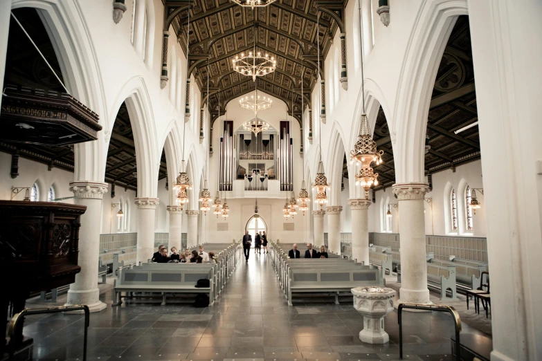 a large cathedral with people milling about inside