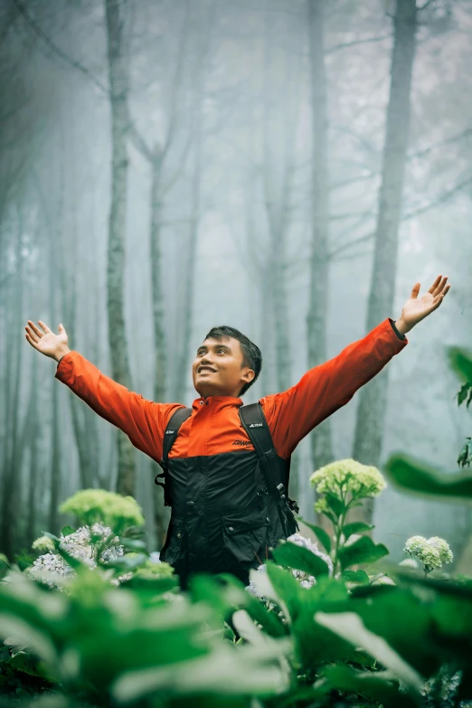 a man with a backpack on in the middle of a forest