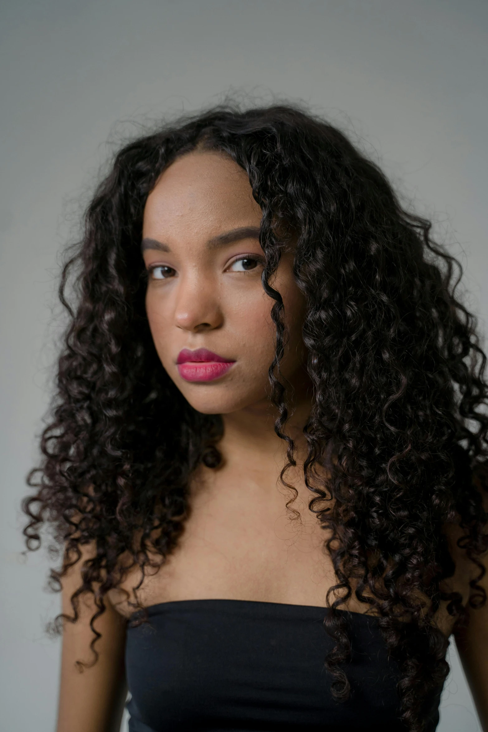 a young woman with long, curly hair