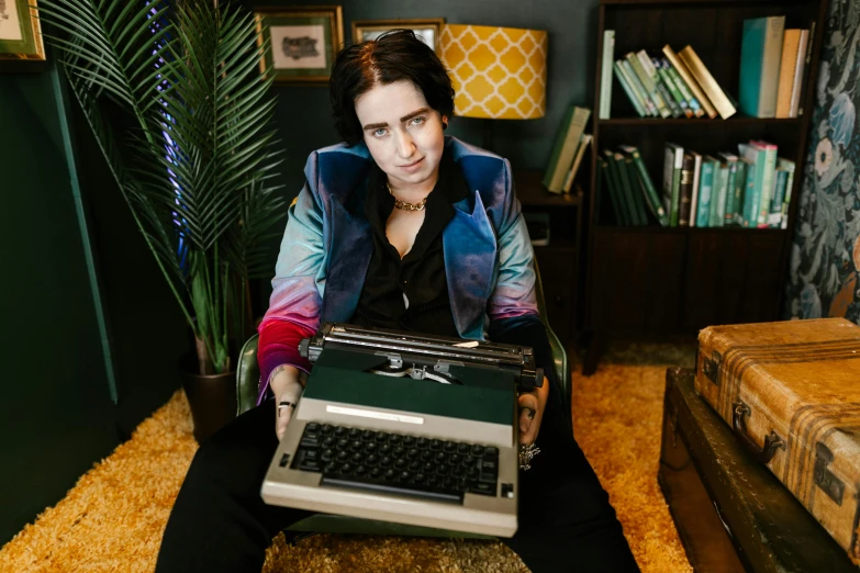 a woman is posing for the camera with a typewriter