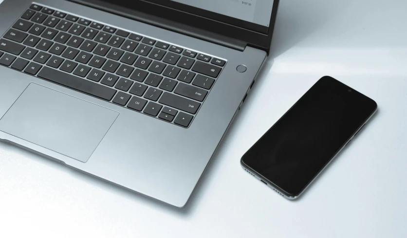 laptop, phone and paper on a desk