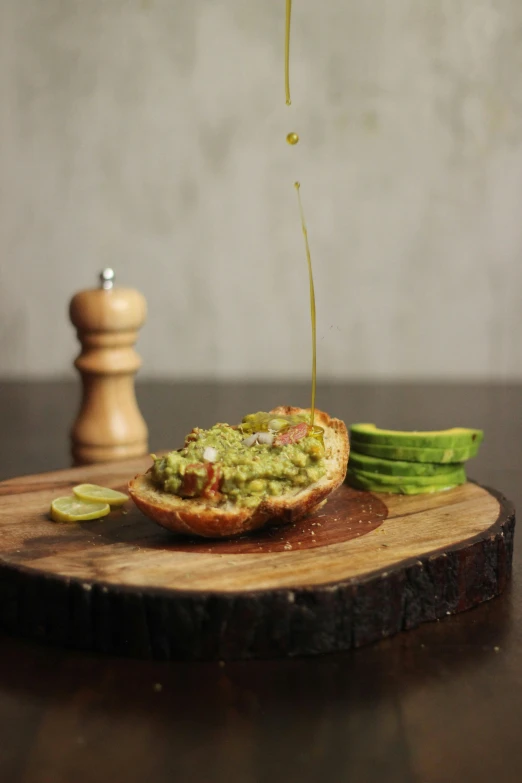 a food item is on a wooden  board with sliced cucumbers