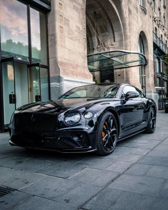 a very sleek car is parked on the side of the street