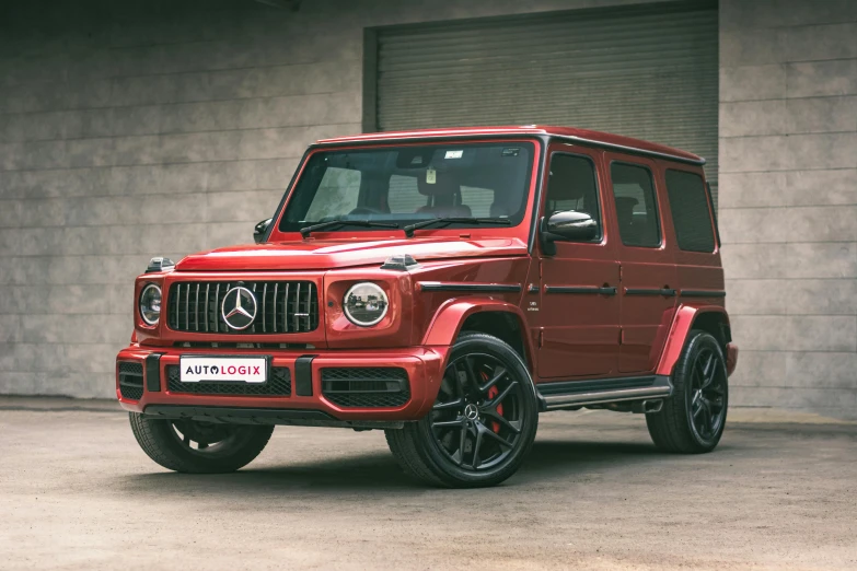 red mercedes benz g - class suv parked in driveway