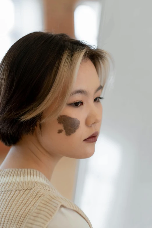 woman with brown and black markings on her face