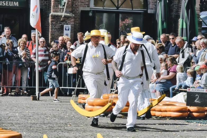 people walking in the sand towards a bunch of floats