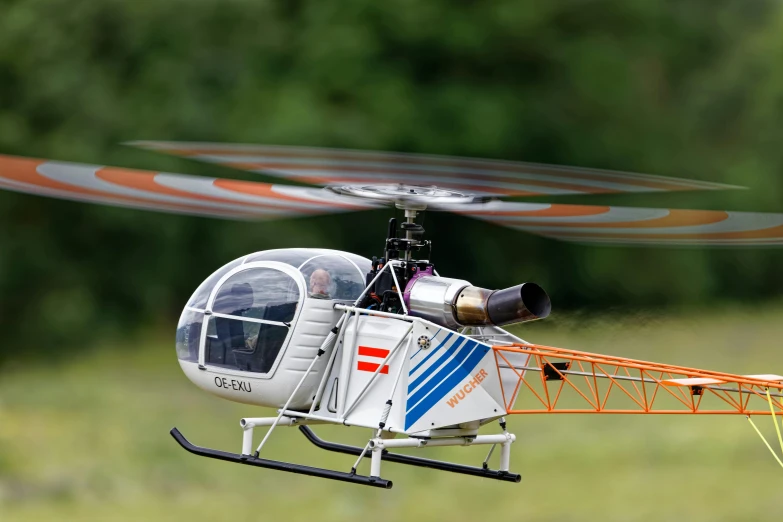 a man in an orange vest sitting inside a helicopter