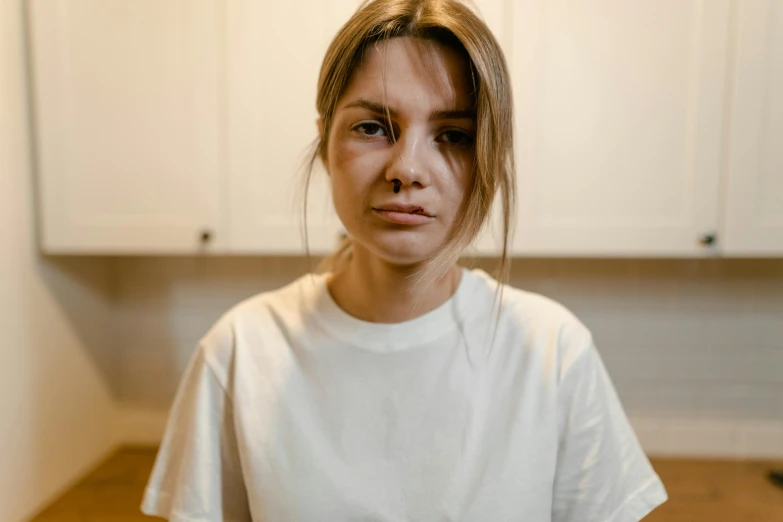 an angry young woman standing in front of the kitchen counter