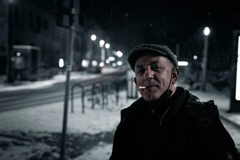 a man standing on a snowy street corner