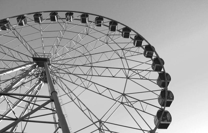 a ferris wheel that is very tall and in black and white