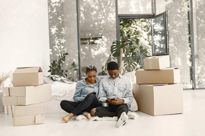 two people sitting in front of boxes