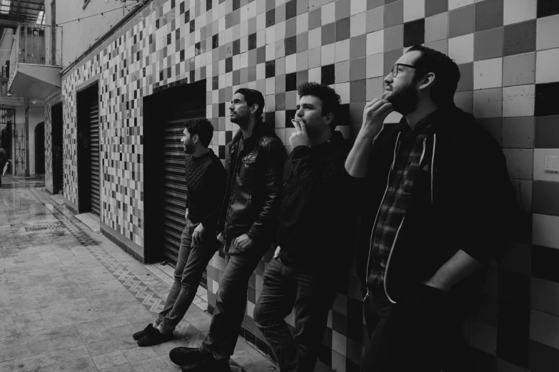 men are lined up against a wall in front of them