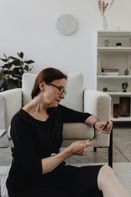 woman sitting in living room with legs crossed reading