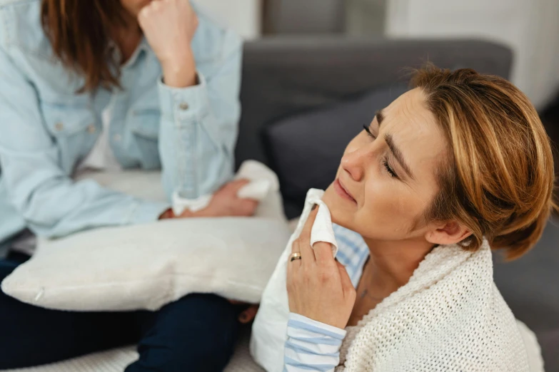 two women sitting on the floor in their living room