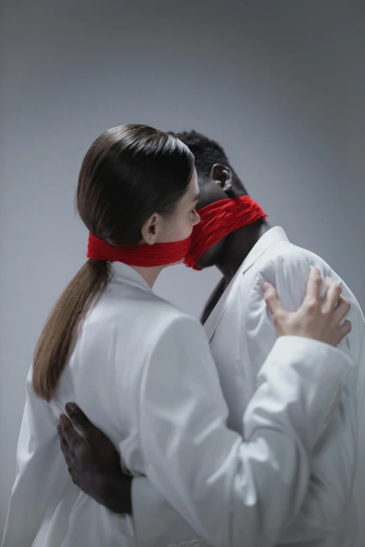 a young man kissing the forehead of a woman