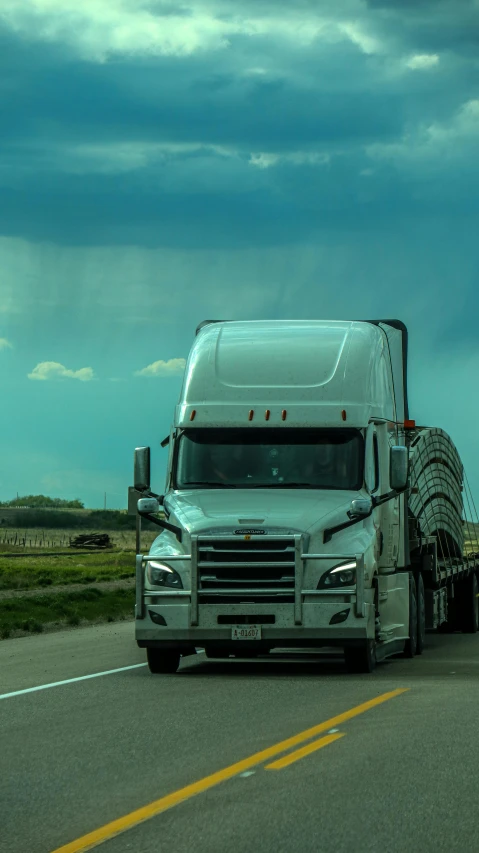 a semi truck pulling a trailer on the road