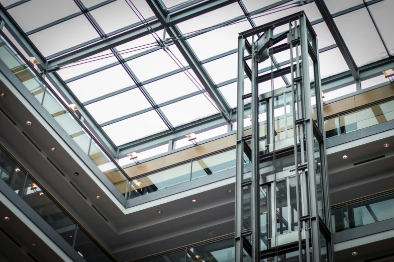 a metal clock tower in a shopping mall