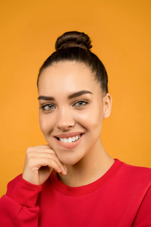 a woman in a red sweater smiling