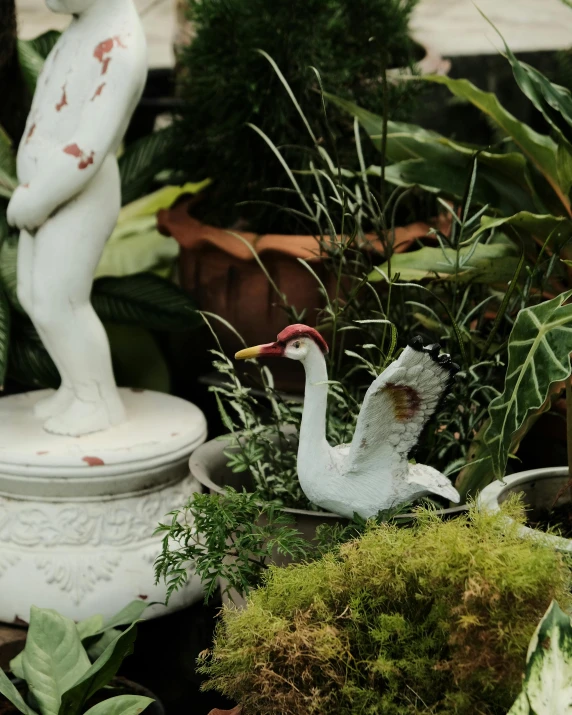 a planter with a white statue in it