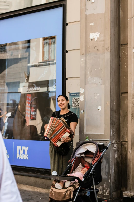 a person holding a large umbrella next to a stroller