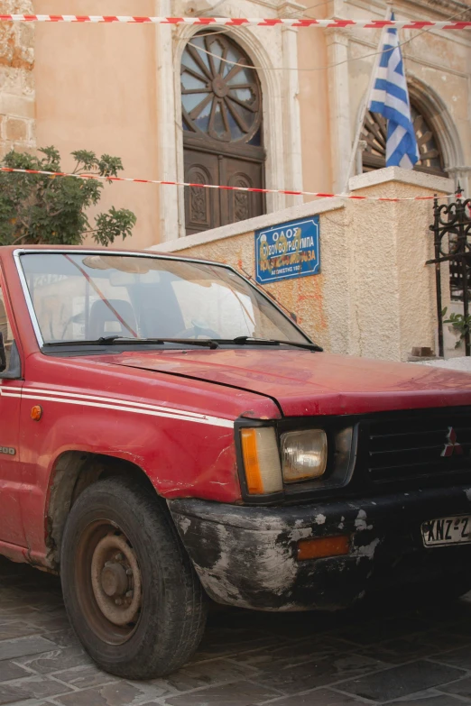 a red truck is parked on the side of the street