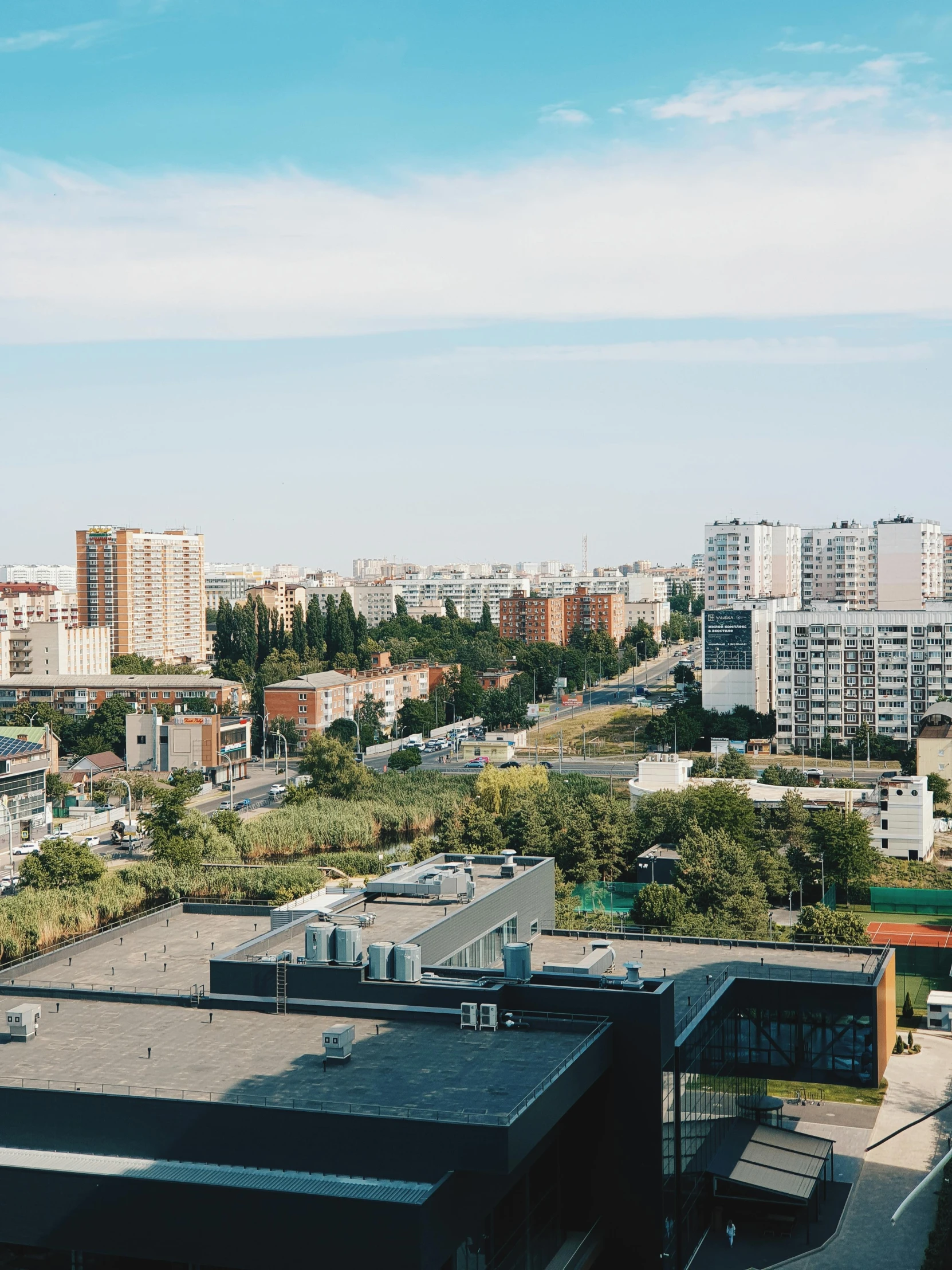 some buildings and cars in the distance near water