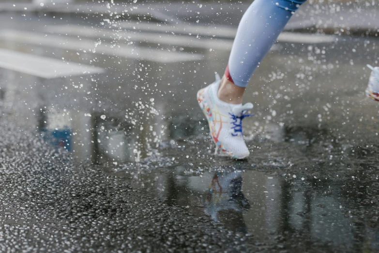 person with blue pants, white tennis shoes and white tights jumping into water